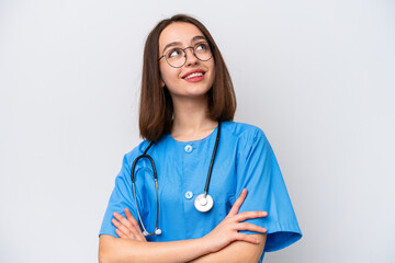 Young nurse Ukrainian woman isolated on white background looking up while smiling