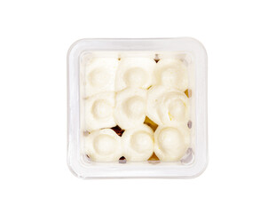 Portion of chocolate caramel mousse in a plastic cup on a white background. View from above.