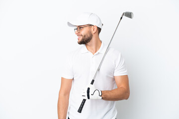 Handsome young man playing golf  isolated on white background looking side