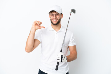 Handsome young man playing golf  isolated on white background proud and self-satisfied