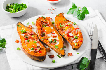 Baked Sweet Potato Stuffed with Egg, Bacon, and Green Onions on Bright Background