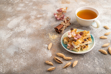 Traditional candy nougat with nuts and sesame, side view, copy space.