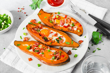 Baked Sweet Potato Stuffed with Egg, Bacon, and Green Onions on Bright Background