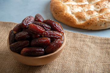 Date fruits,traditional Ramadan pita on bright background,top view
