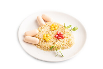 Funny quinoa porridge, and small sausages in form of cat face isolated on white. side view.