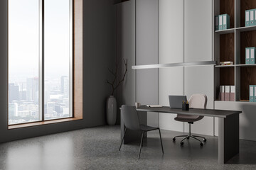 Grey consulting interior with ceo desk and laptop, shelf and panoramic window