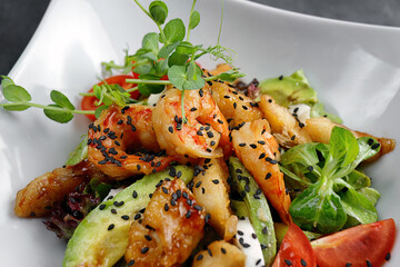 Grilled prawns with avocado, tomatoes, and quail eggs