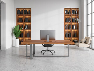 Modern office interior with work table and computer, armchair and shelves