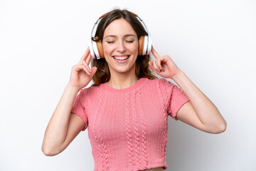 Young caucasian woman isolated on white background listening music and singing