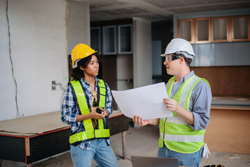 Engineers are discussing data working and laptop or tablet with architectural project at new construction site on big project..