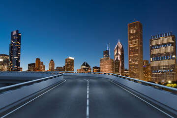 Fototapeta premium Empty urban asphalt road exterior with city buildings background. New modern highway concrete construction. Concept of way to success. Transportation logistic industry fast delivery. Chicago. USA.