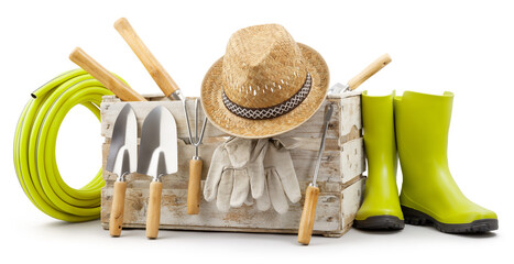 Gardening tools set, wooden crate with garden kit, rubber green boots, hose, handle trowel, straw hat and protective gloves, isolated on white background. Concept of work or sale garden products
