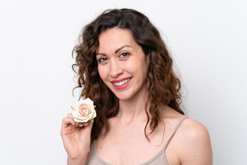 Young caucasian woman isolated on white background holding flowers with happy expression. Close up portrait