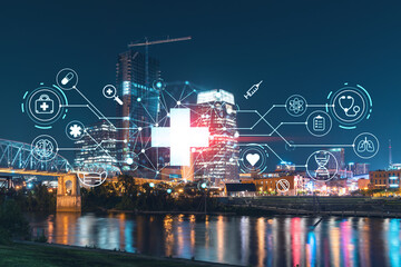Panoramic view of Broadway district of Nashville over Cumberland River at illuminated night skyline, Tennessee, USA. Hologram healthcare digital medicine icons. The concept of treatment from disease