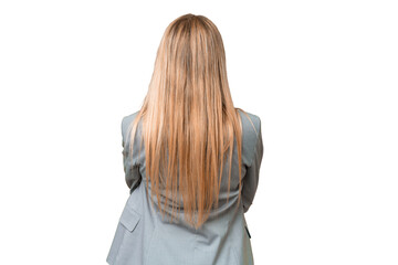 Young pretty blonde woman over isolated chroma key background in back position