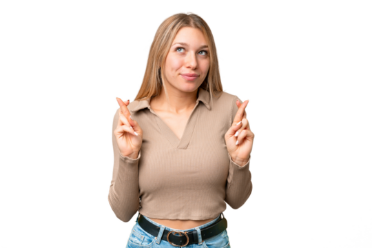 Young pretty blonde woman over isolated chroma key background with fingers crossing and wishing the best