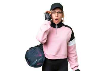 Pretty sport woman with sport bag over isolated chroma key background with glasses and surprised