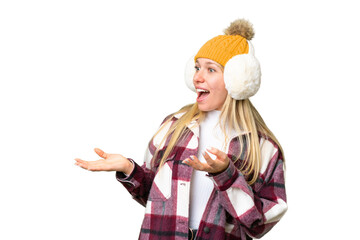 Young pretty blonde woman wearing winter muffs over isolated chroma key background with surprise facial expression