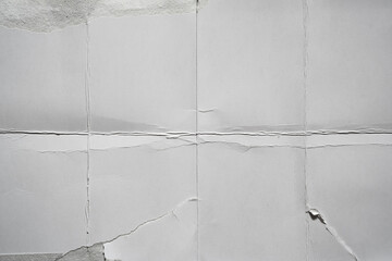 White damaged paper background folded into eight parts
