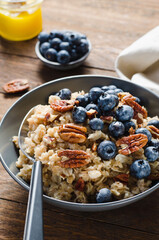 Oatmeal Bowl, Oat Porridge with Blueberry and Pecans in a Bowl on Rustic Background, Healthy Snack or Breakfast