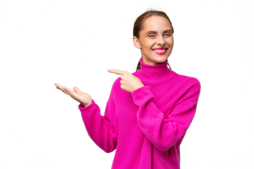 Young caucasian woman over isolated background holding copyspace imaginary on the palm to insert an ad