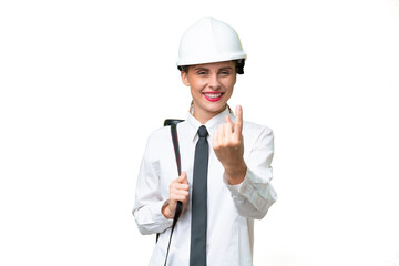 Young architect woman with helmet and holding blueprints over isolated background doing coming gesture