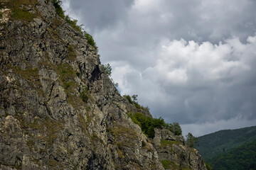 Tranquil scenic view of majestic rocky mountains against cloudy sky. Copy space. Selective focus.