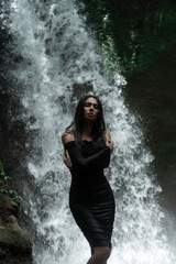 Young sexy woman posing at the waterfall in jungles. Ecotourism concept image travel girl