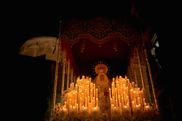 Frontal shot of the throne of the Virgin Mary Most Holy of Faith and Charity with candles lit...