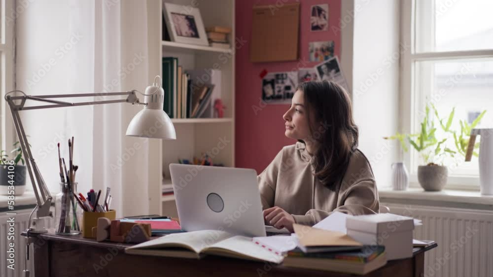 Poster young teenage girl studying in her room.