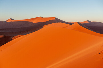 Naklejka na ściany i meble Exterior shot of the Namibian Sossusvlei sanddunes near the famous Dune 45 around sunrise