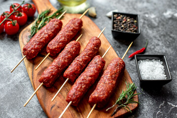 Homemade lula kebab from raw meat on a stone background
