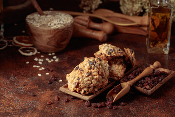 Oatmeal raisin cookies on a brown table.