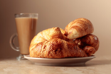 Freshly baked croissants and coffee with cream.