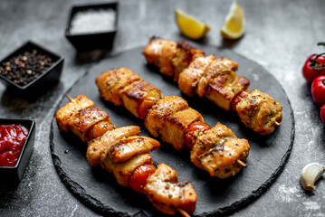 salmon kebab on skewers,grilled on a stone background.