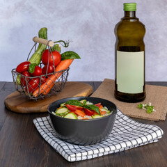 A bowl containing white rice with chopped vegetables and basil leaves next to a basket of whole vegetables and a bottle of Italian extra virgin olive oil