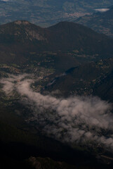 View on clouds over mountain village in Alps