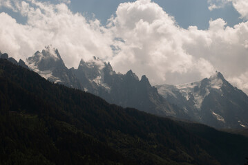 View on white clouds over mountains in Alps