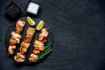 salmon kebab on skewers,grilled on a stone background with copy space for your text