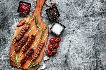 Grilled homemade lula kebab on a stone background with copy space for your text