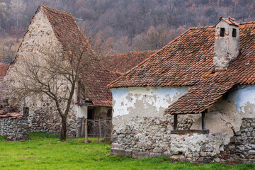 Old stone house in a Transylvania village.  Romania, Harghita County, Comanesti. - 585356110