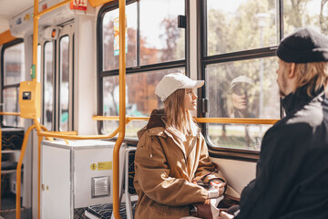 Young beautiful woman looking through the train window. Happy bus passenger traveling sitting in a...