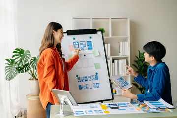 Asian businessman and woman people meeting in office. Employee brainstorm and work as team, plan and discuss project by point on paper and tablet.