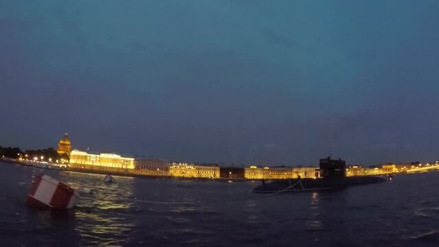 Sailing on a boat in a city river at night in summer. Passenger touristic ship.