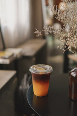 Americano coffee with orange juice. Blank coffee with disposable plastic cup.