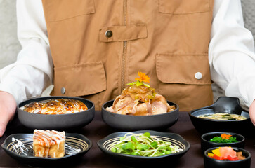 Grilled Pork Belly Sliced ​​Rice with Fragrant Sauce Topped with Stir Fried Onions Served with salad and special soybean paste soup and Japanese side dishes.