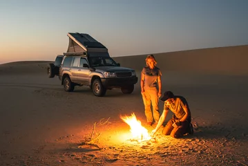A couple with a 4x4 camper start a fire in the Saudi desert © JoergSteber