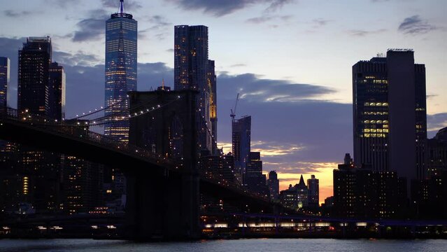 Brooklyn bridge at night with skyscrapers