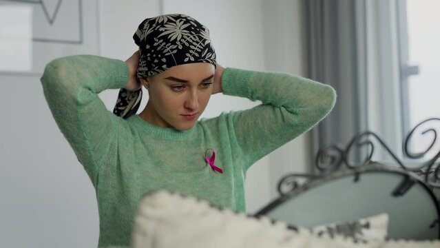 Beauty routine of young woman with cancer, getting scarf.