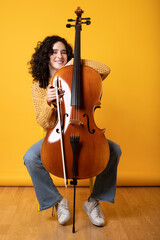 Casual girl posing with her violoncello